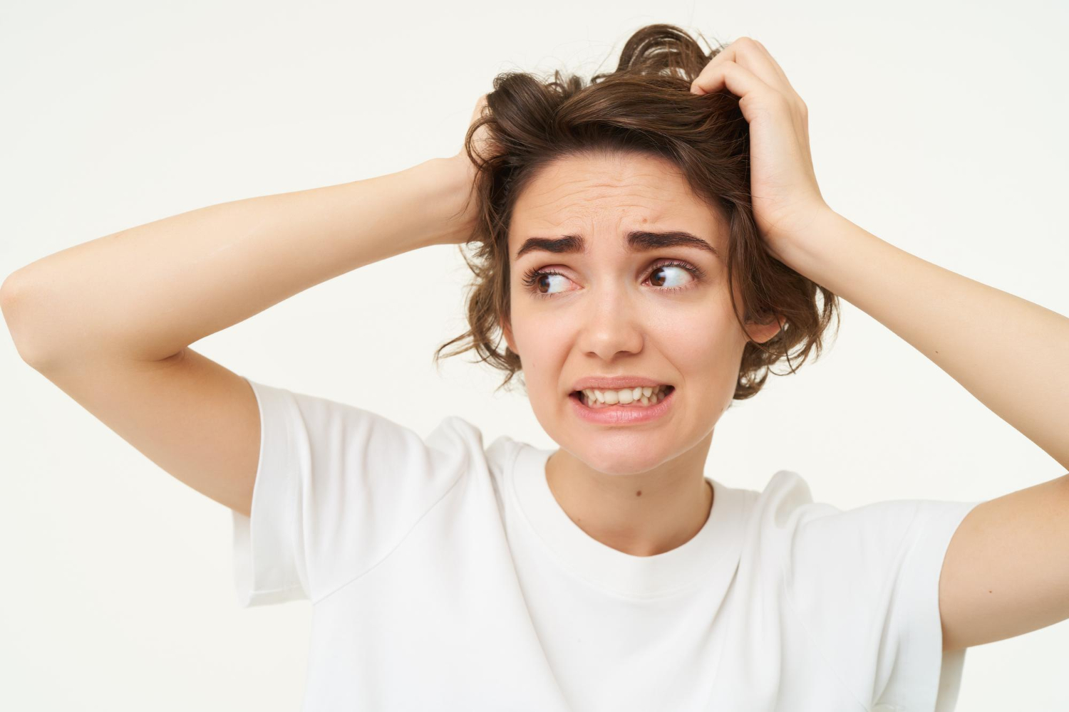 Image depicting a person scratching their scalp with the question: Could a Vitamin Deficiency Be Your Scalps Itching? overlaid